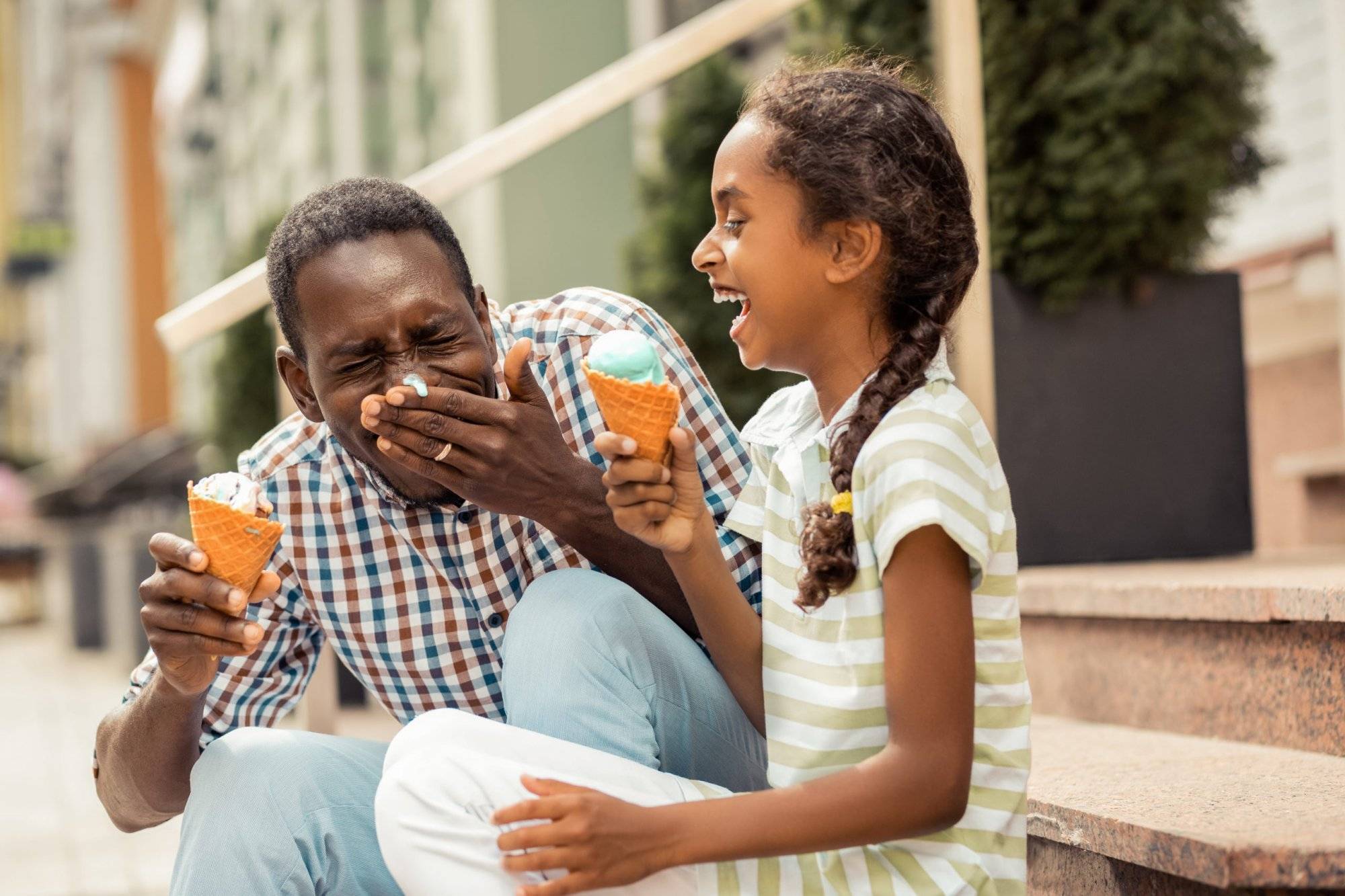 Creative father. Charming teenager laughing at funny situation, spending time with her daddy